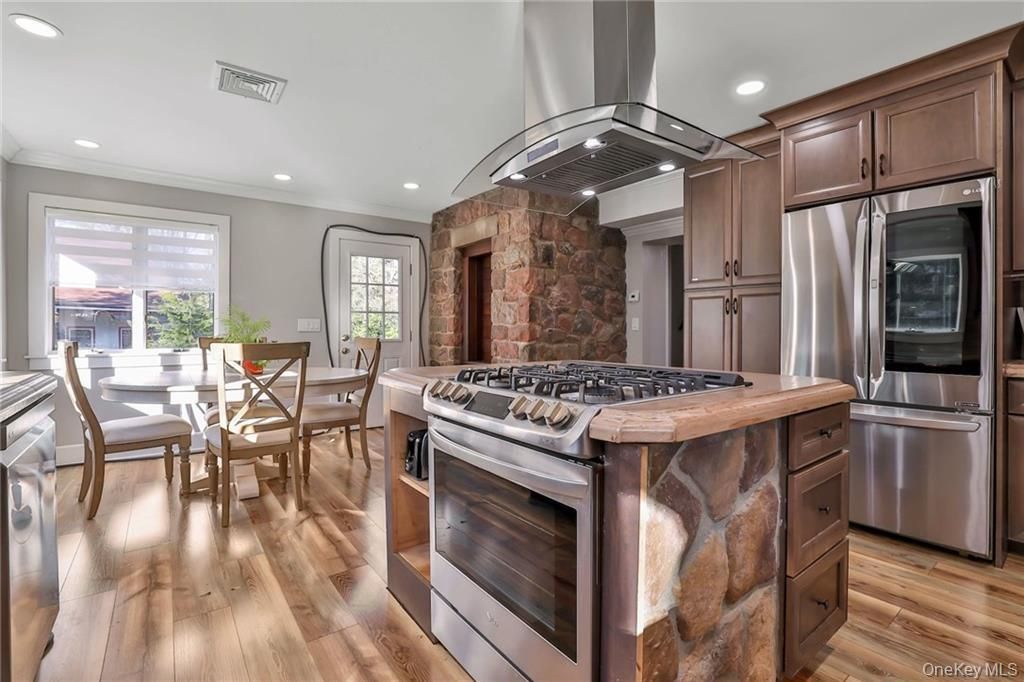 Dining room, Interior, Kitchen, Recessed Lighting, Stainless Steel Appliances, Stone Walls, Wood Texture Flooring