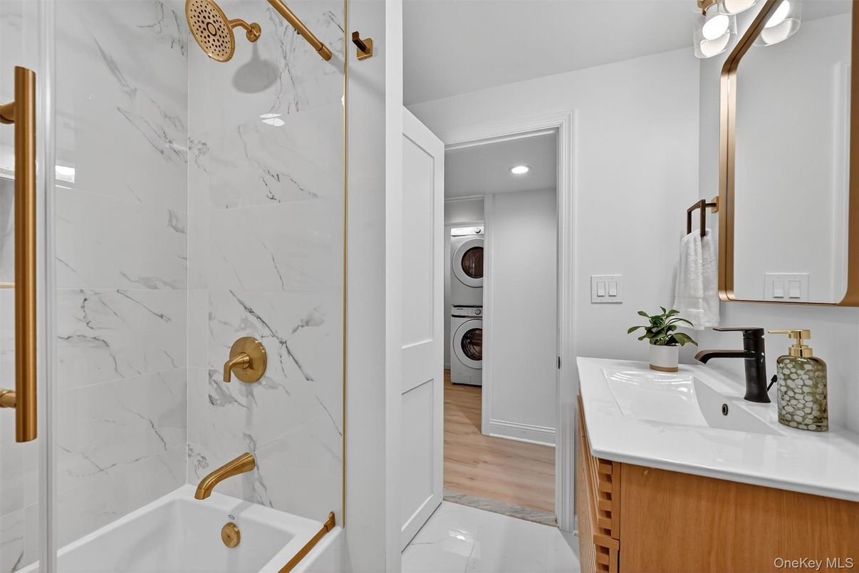 Bathroom, Interior, Marble Walls, Recessed Lighting, Utility Closets, Washer, Wood Texture Flooring