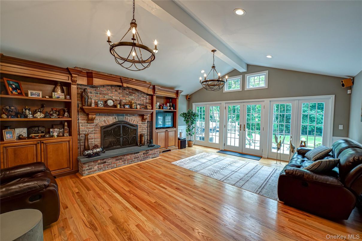 Chandelier, Fireplace, Interior, Living room, Recessed Lighting, Stone Walls, Wood Texture Flooring