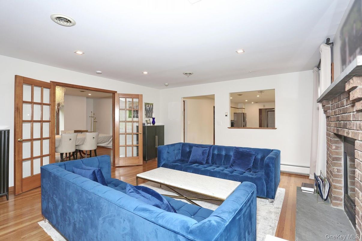 Dining room, Fireplace, Interior, Living room, Recessed Lighting, Wood Texture Flooring