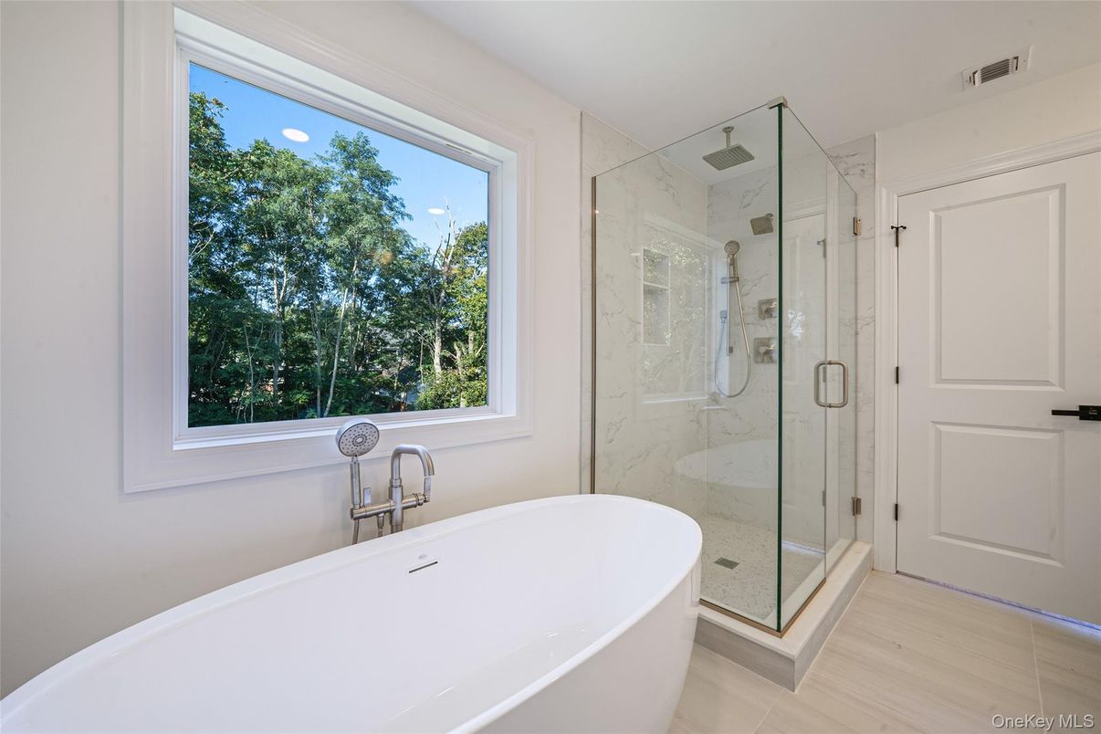 Bathroom, Free Standing Baths, Glass Shower, Interior, Marble Walls, Recessed Lighting, Wood Texture Flooring