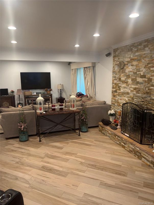 Fireplace, Interior, Living room, Recessed Lighting, Stone Walls, Wood Texture Flooring
