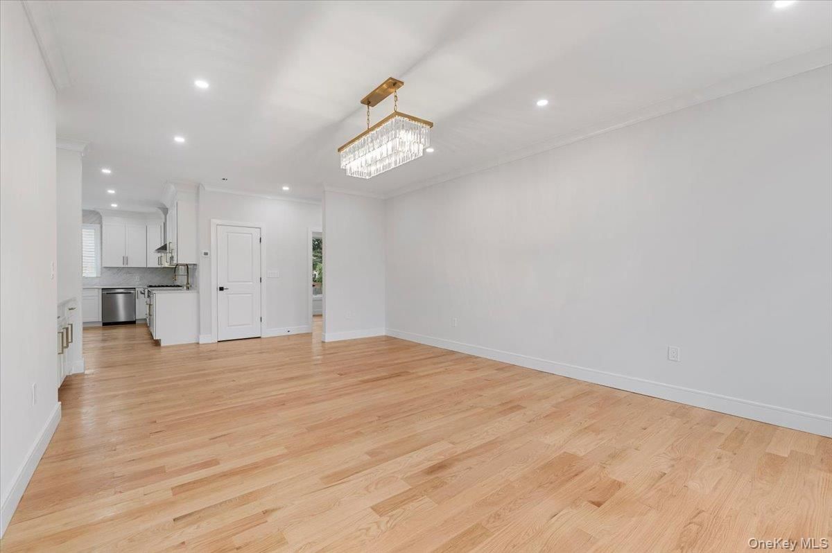 Chandelier, Empty room, Interior, Kitchen, Recessed Lighting, Stainless Steel Appliances, Wood Texture Flooring