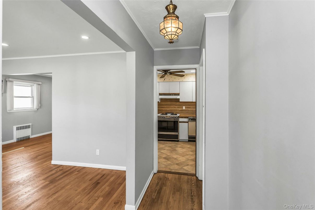 Empty room, Interior, Kitchen, Recessed Lighting, Stainless Steel Appliances, Wood Texture Flooring