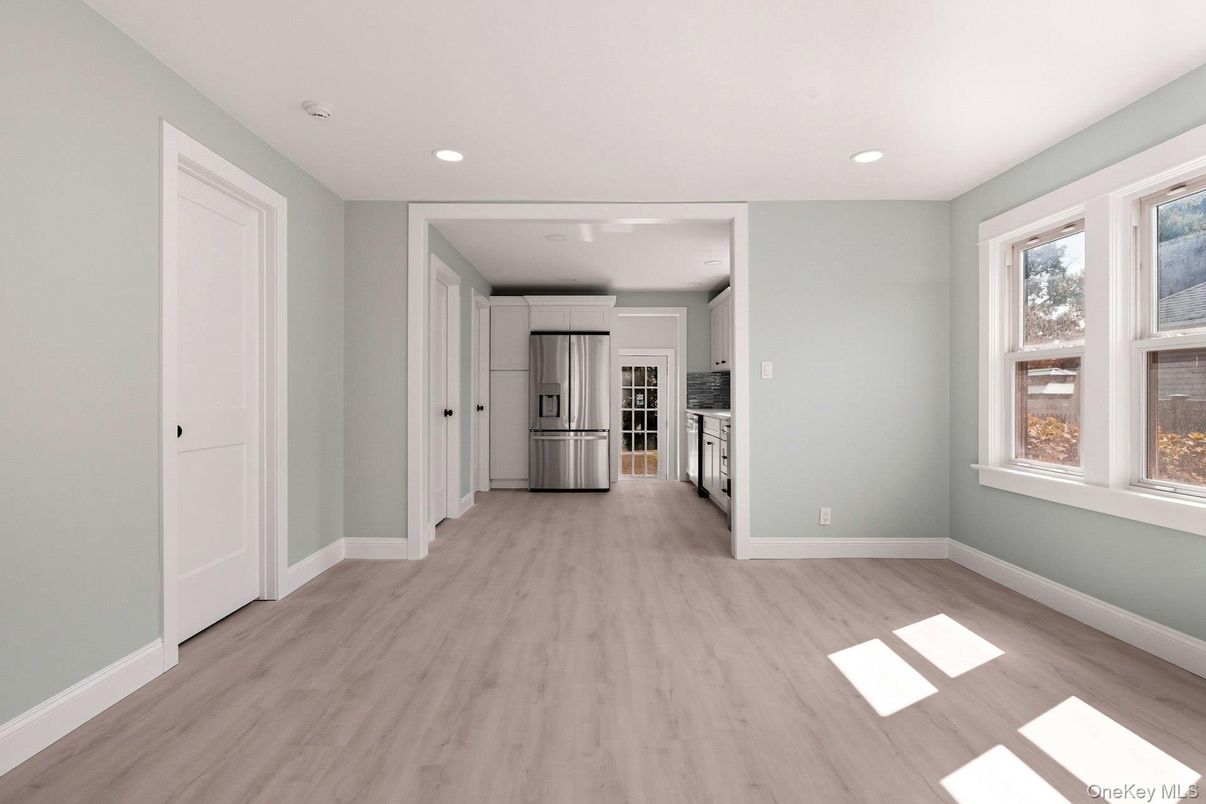 Empty room, Interior, Kitchen, Recessed Lighting, Stainless Steel Appliances, Wood Texture Flooring