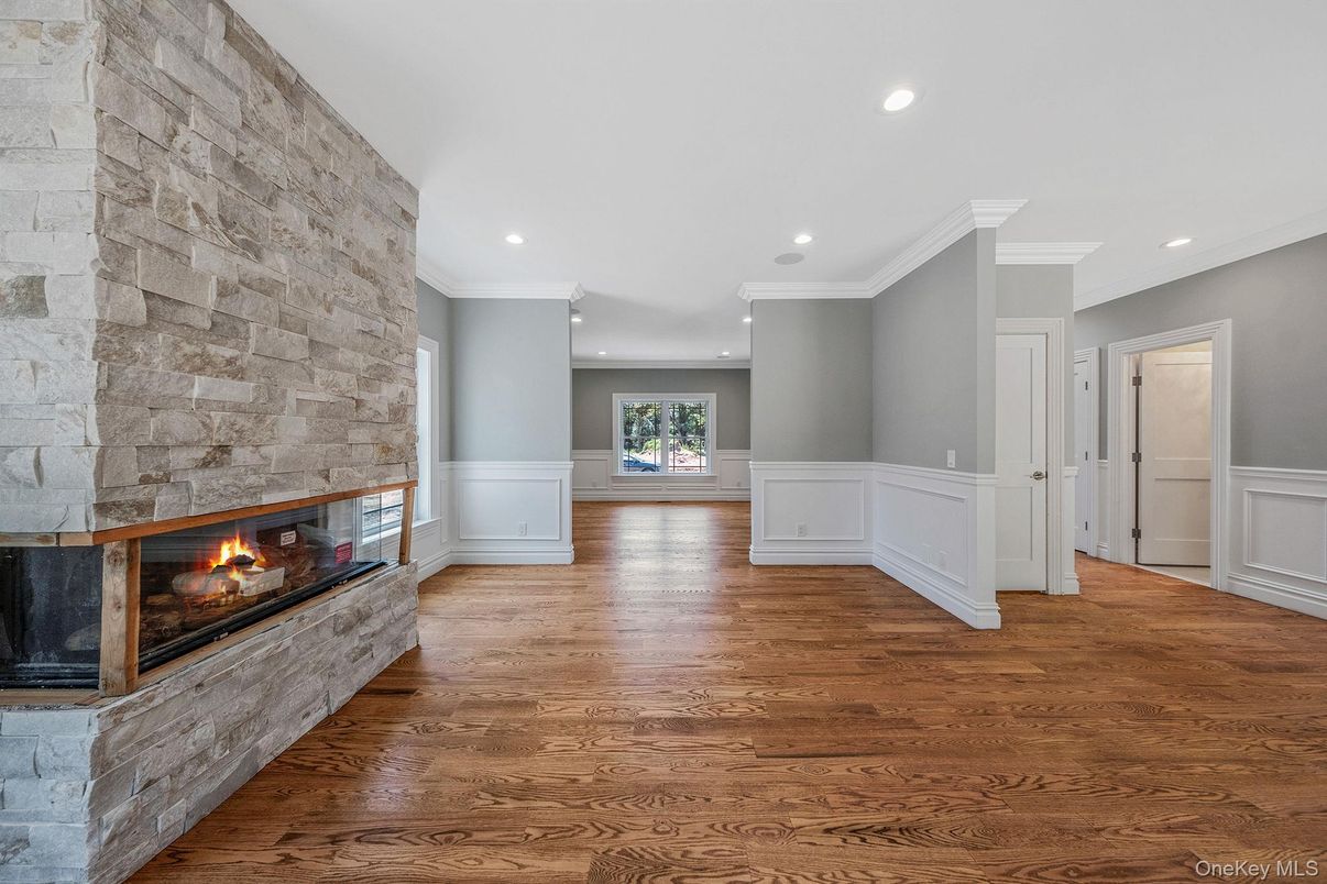 Empty room, Fireplace, Interior, Recessed Lighting, Stone Walls, Wood Texture Flooring
