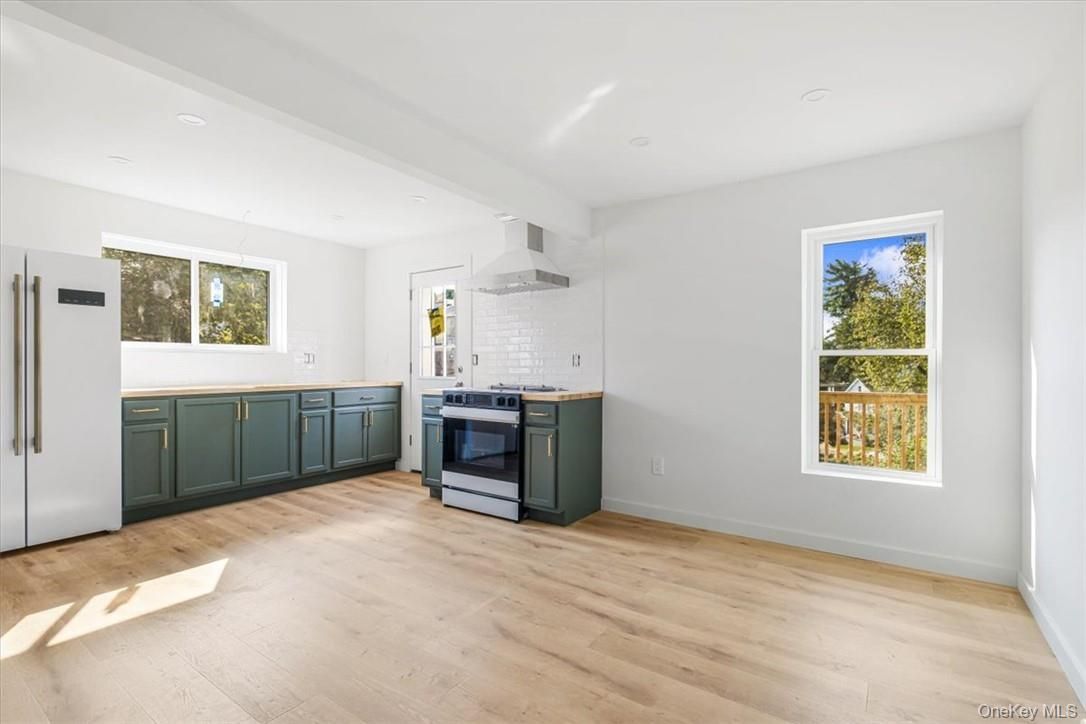 Empty room, Interior, Kitchen, Recessed Lighting, Stainless Steel Appliances, Wood Texture Flooring