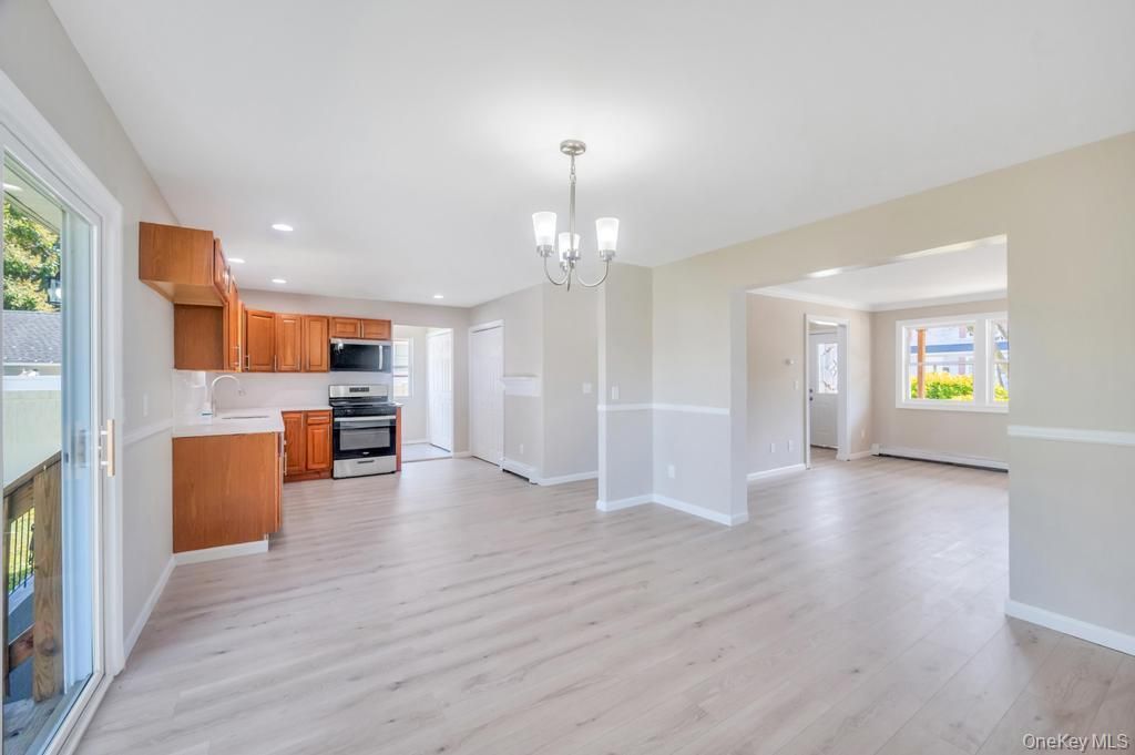 Chandelier, Empty room, Interior, Kitchen, Pendant Lights, Recessed Lighting, Stainless Steel Appliances, Wood Texture Flooring