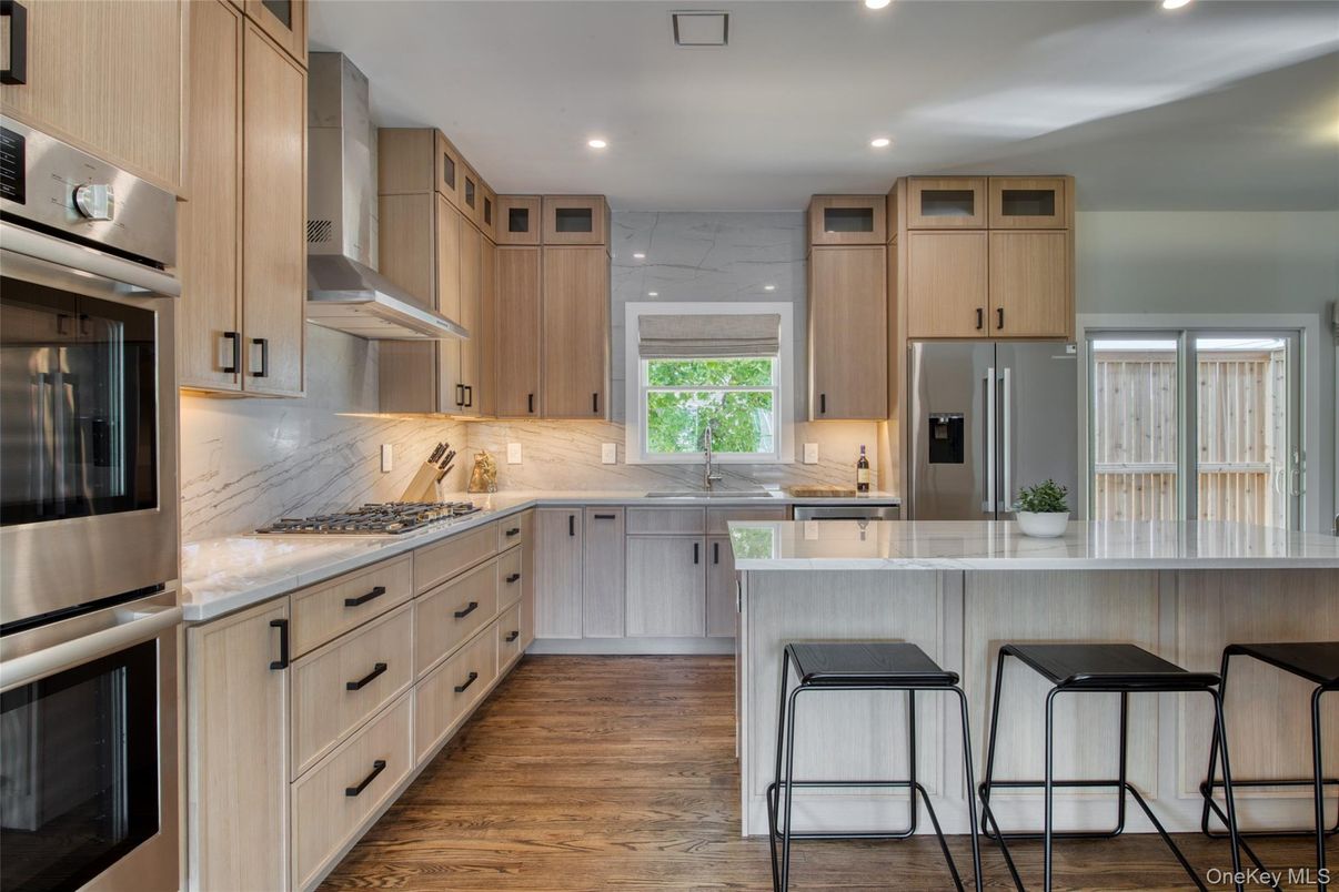Interior, Kitchen, Marble Walls, Recessed Lighting, Stainless Steel Appliances, Wood Texture Flooring