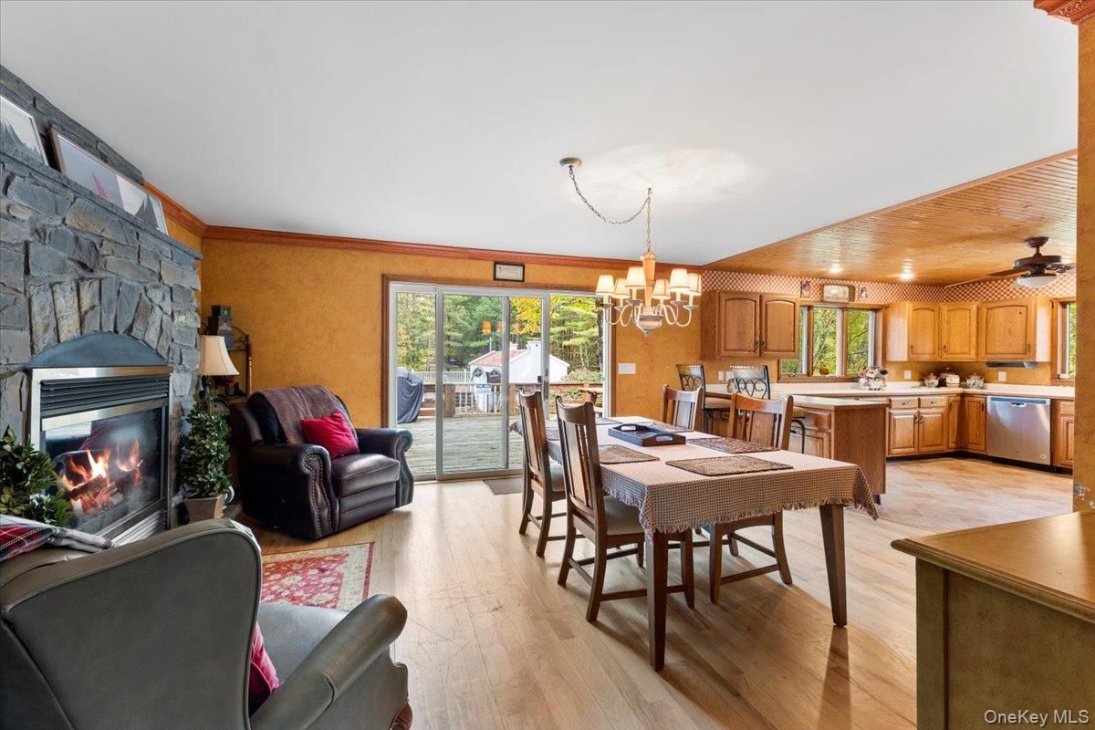 Chandelier, Dining room, Fireplace, Interior, Kitchen, Living room, Recessed Lighting, Stone Walls, Wood Texture Flooring