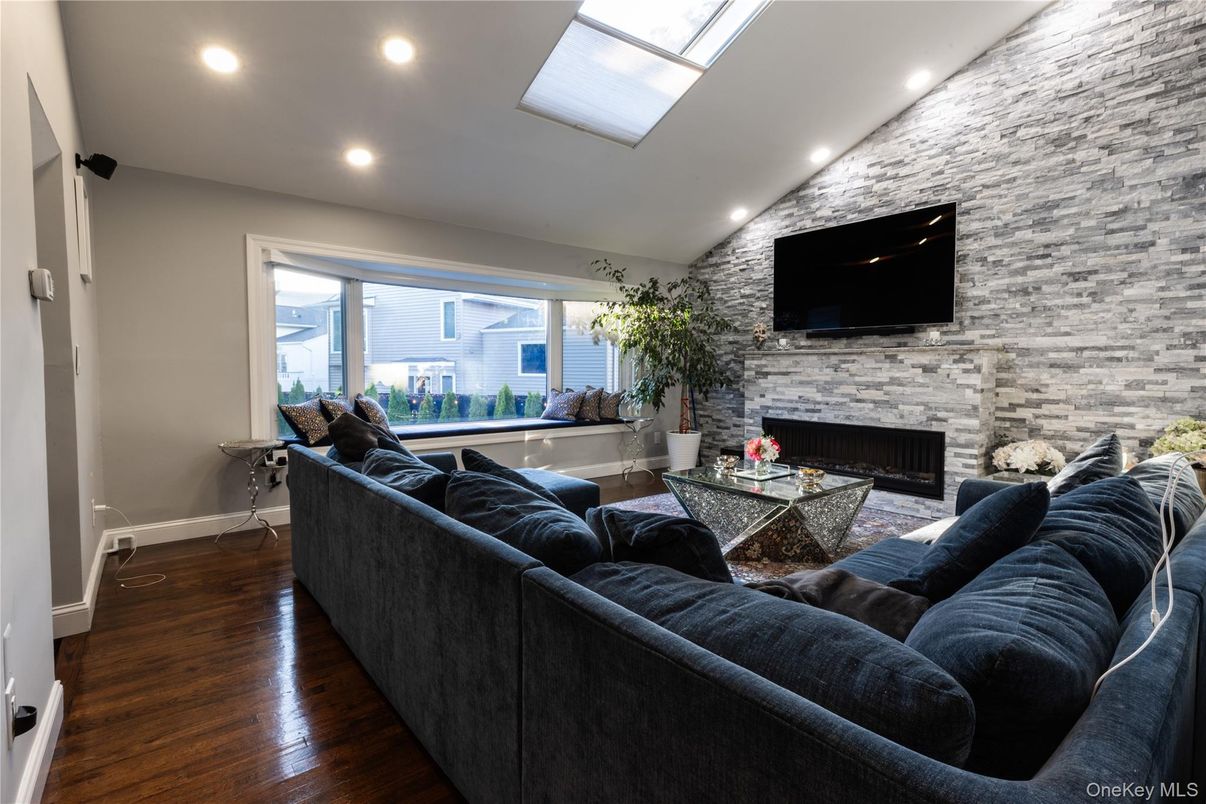 Fireplace, Interior, Living room, Recessed Lighting, Stone Walls, Wood Texture Flooring