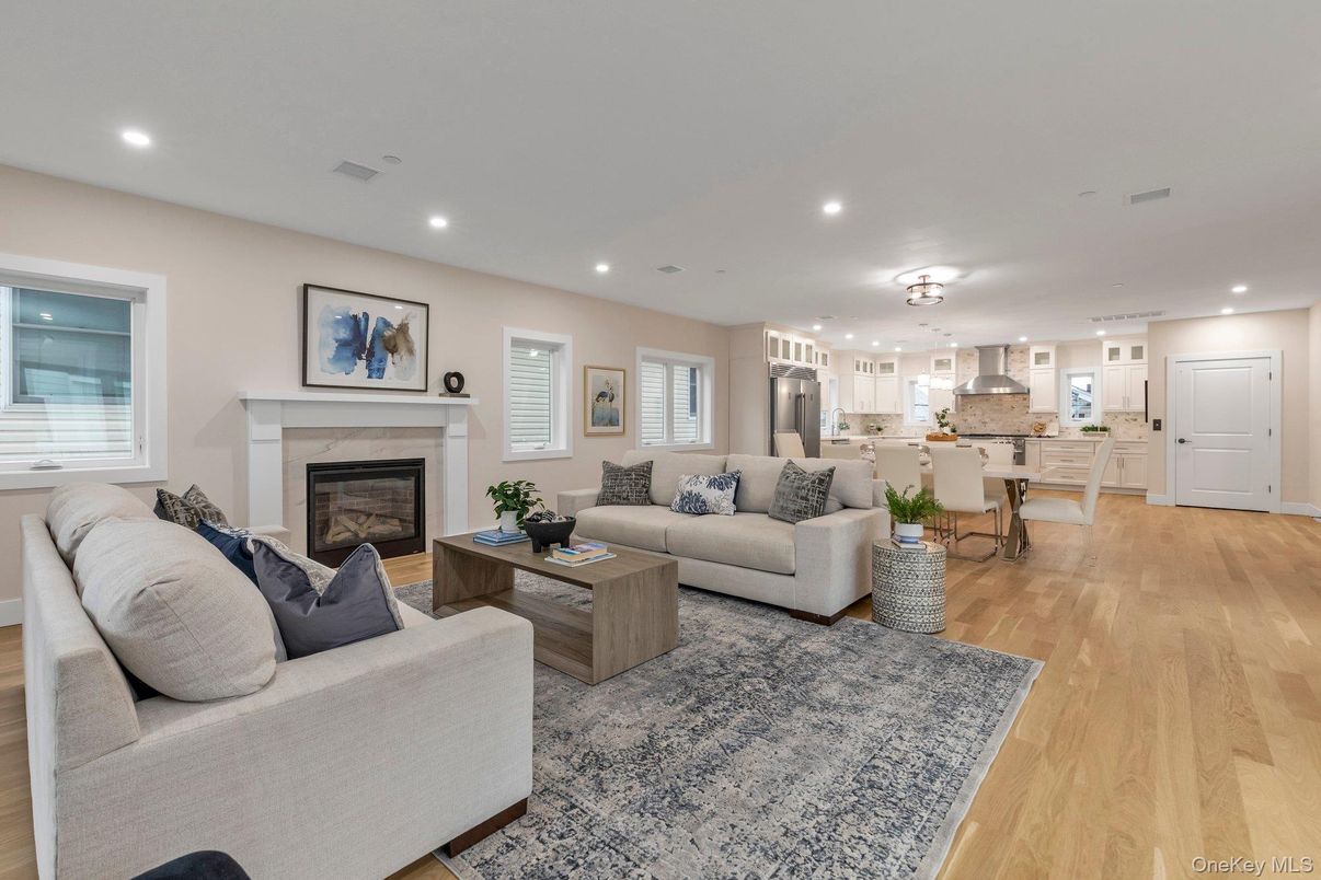 Dining room, Fireplace, Interior, Kitchen, Living room, Pendant Lights, Recessed Lighting, Stainless Steel Appliances, Wood Texture Flooring