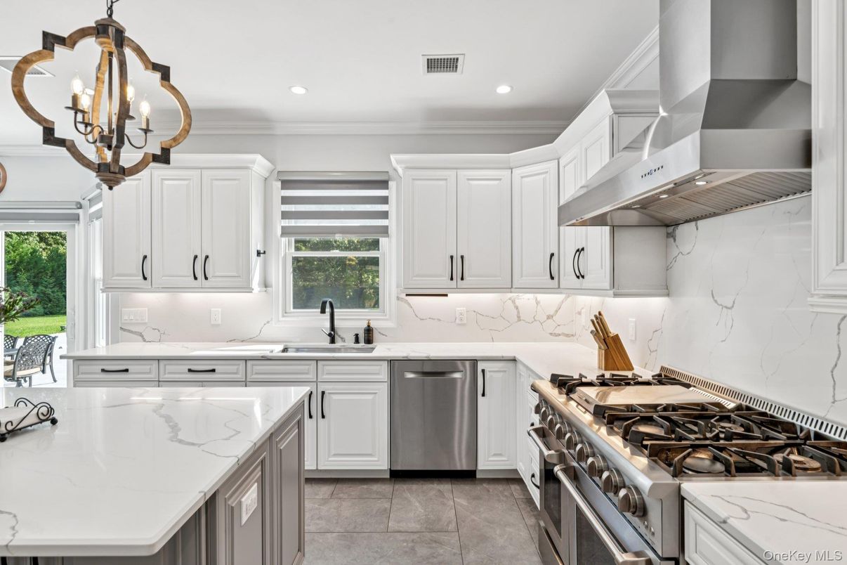 Chandelier, Interior, Kitchen, Marble Walls, Recessed Lighting, Stainless Steel Appliances