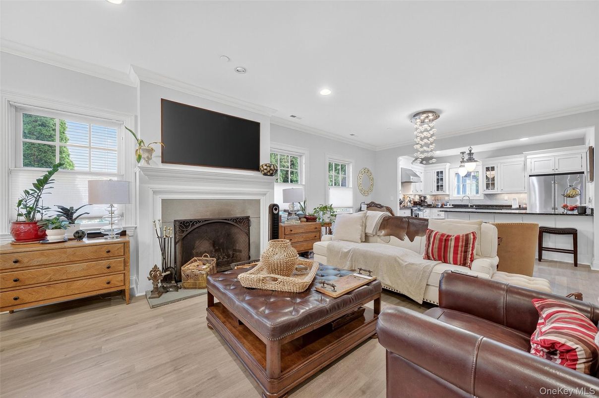 Chandelier, Dining room, Fireplace, Interior, Kitchen, Living room, Pendant Lights, Recessed Lighting, Stainless Steel Appliances, Wood Texture Flooring