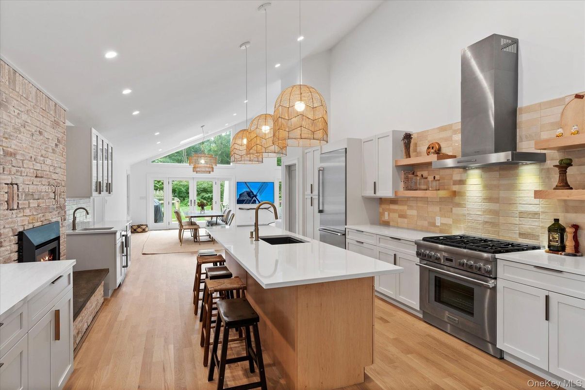Fireplace, Interior, Kitchen, Pendant Lights, Recessed Lighting, Stainless Steel Appliances, Stone Walls, Wood Texture Flooring