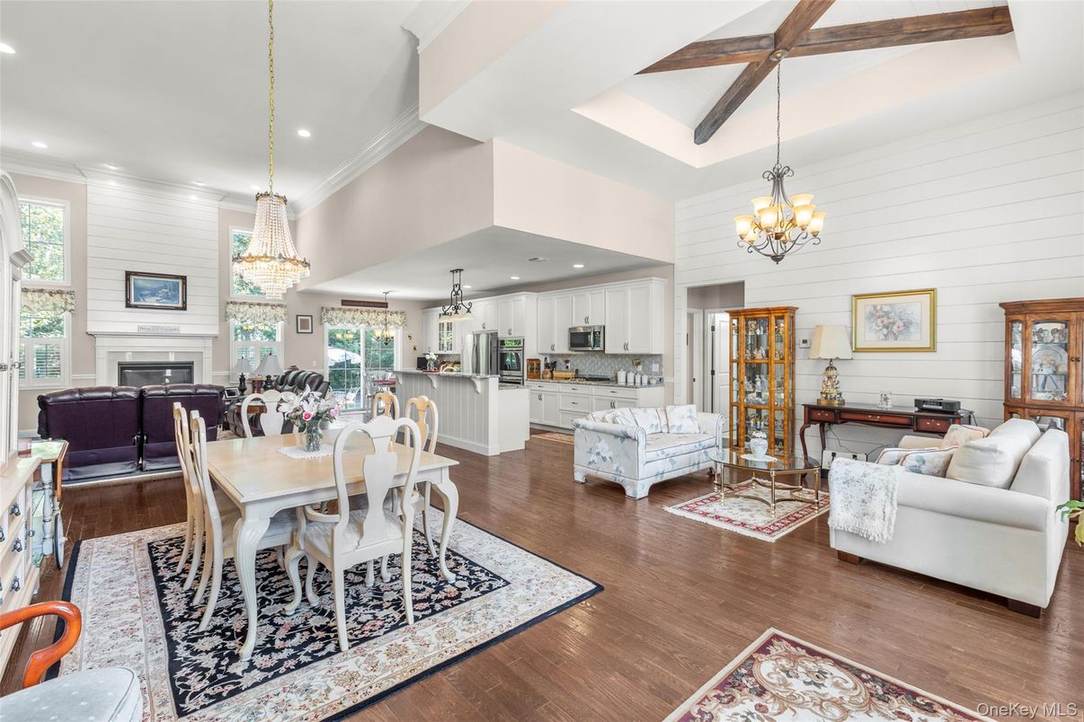 Chandelier, Dining room, Fireplace, Interior, Kitchen, Living room, Pendant Lights, Recessed Lighting, Stainless Steel Appliances, Wooden Beams, Wood Texture Flooring