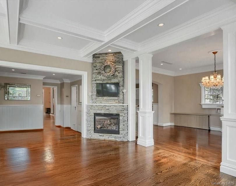 Chandelier, Empty room, Fireplace, Interior, Recessed Lighting, Stone Walls, Wood Texture Flooring
