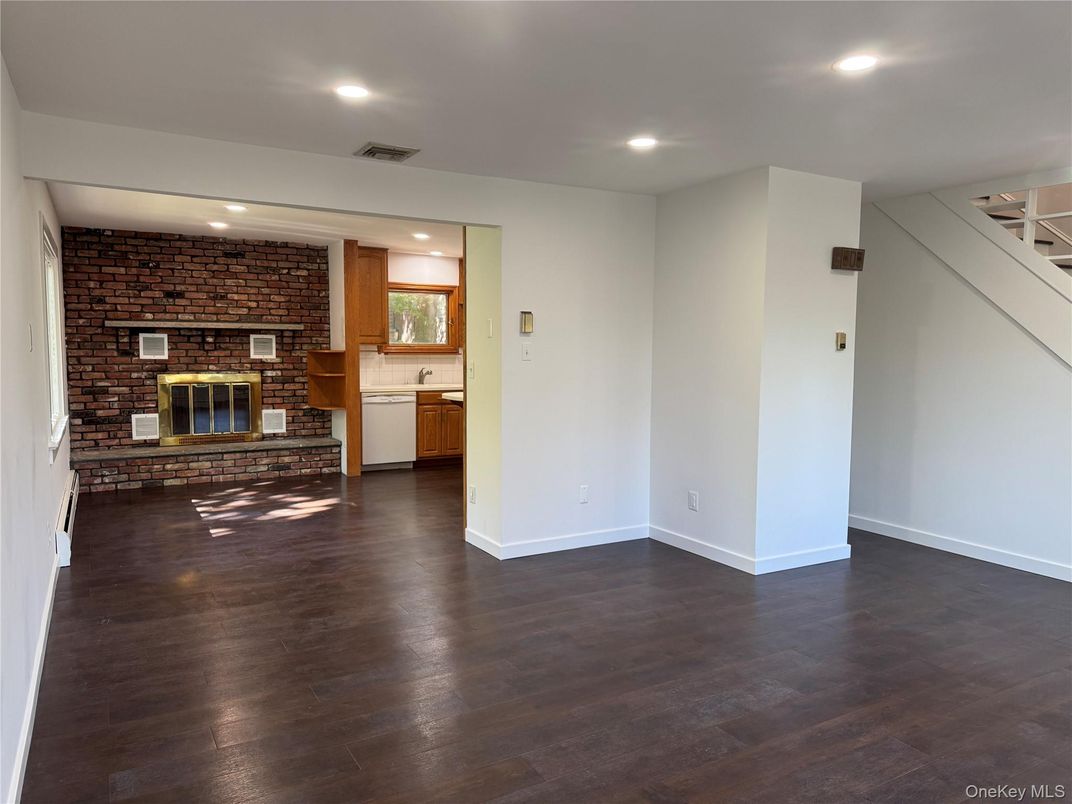Empty room, Fireplace, Interior, Recessed Lighting, Stone Walls, Wood Texture Flooring