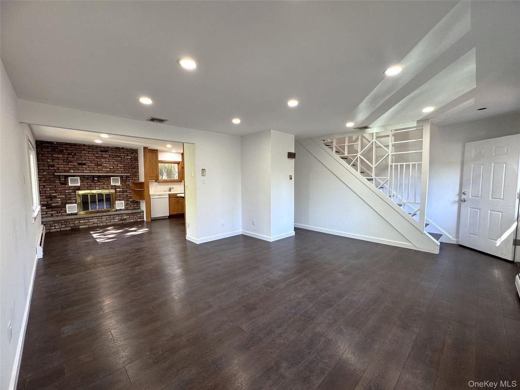 Empty room, Fireplace, Interior, Kitchen, Recessed Lighting, Stone Walls, Wood Texture Flooring