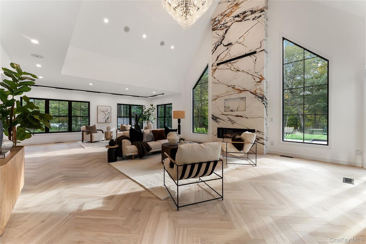 Chandelier, Fireplace, Interior, Living room, Marble Walls, Recessed Lighting, Wood Texture Flooring