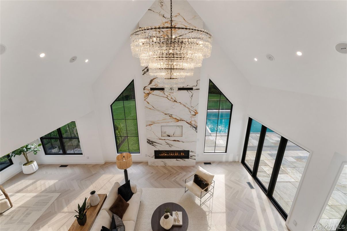 Chandelier, Fireplace, Interior, Living room, Marble Walls, Recessed Lighting, Wood Texture Flooring