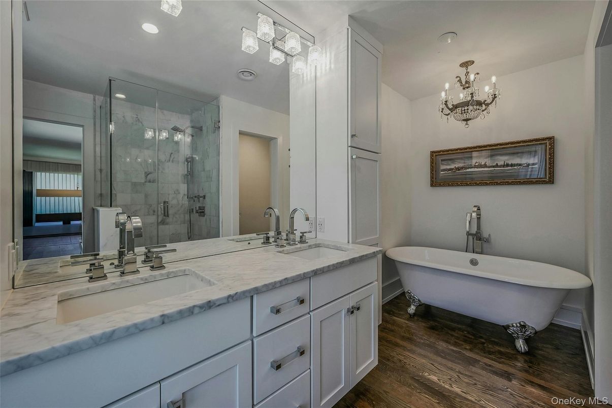 Bathroom, Chandelier, Dual Sink Vanities, Free Standing Baths, Glass Shower, Interior, Recessed Lighting, Wood Texture Flooring
