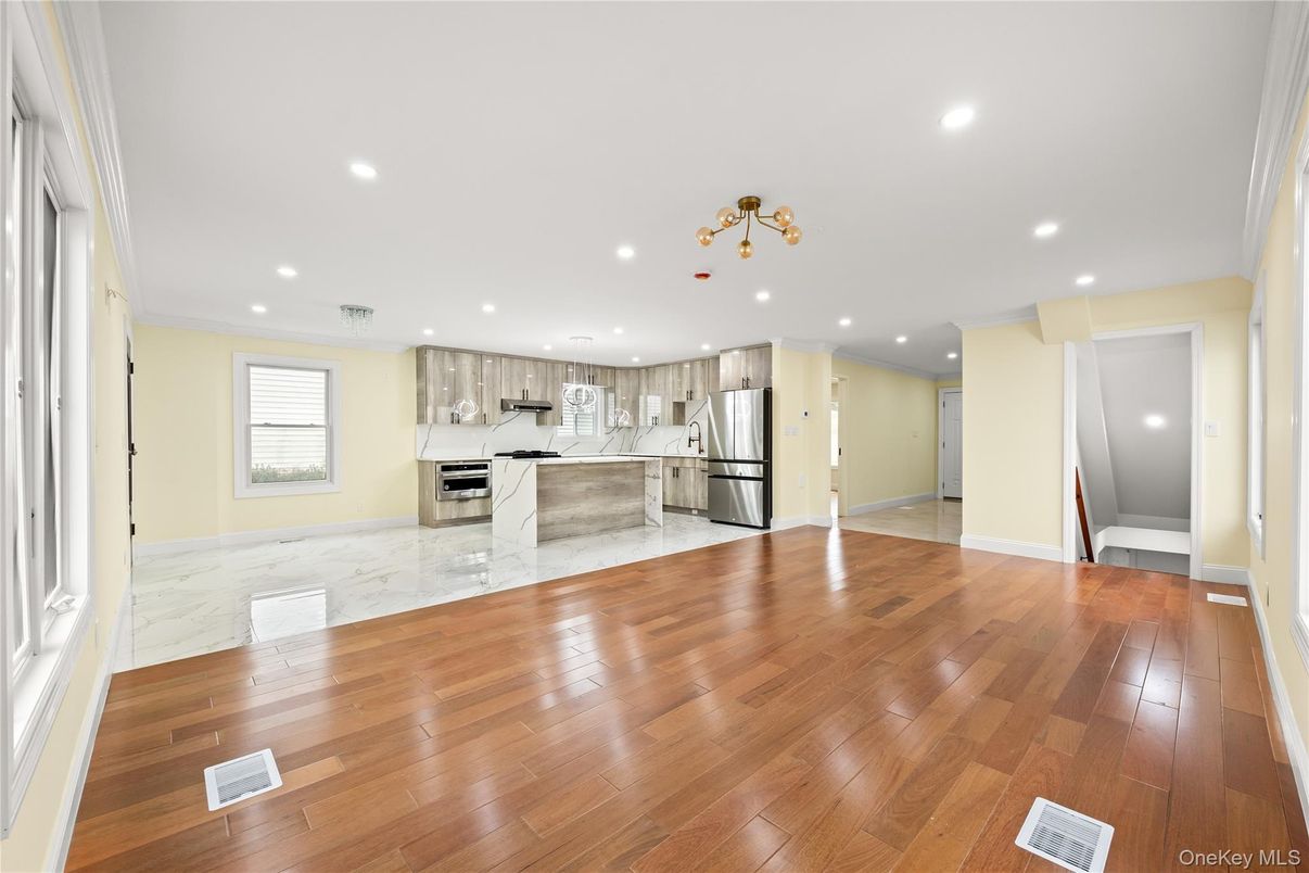 Empty room, Interior, Kitchen, Marble, Recessed Lighting, Stainless Steel Appliances, Wood Texture Flooring