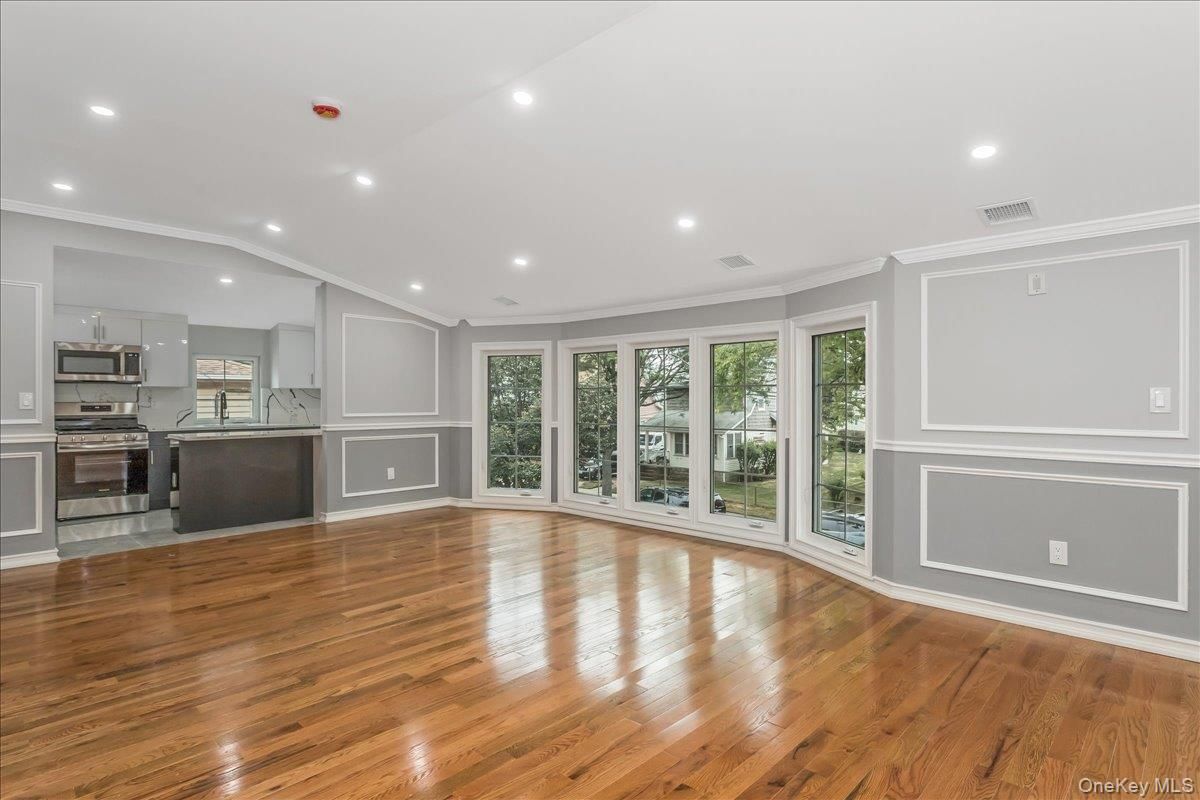 Empty room, Interior, Kitchen, Recessed Lighting, Stainless Steel Appliances, Wood Texture Flooring