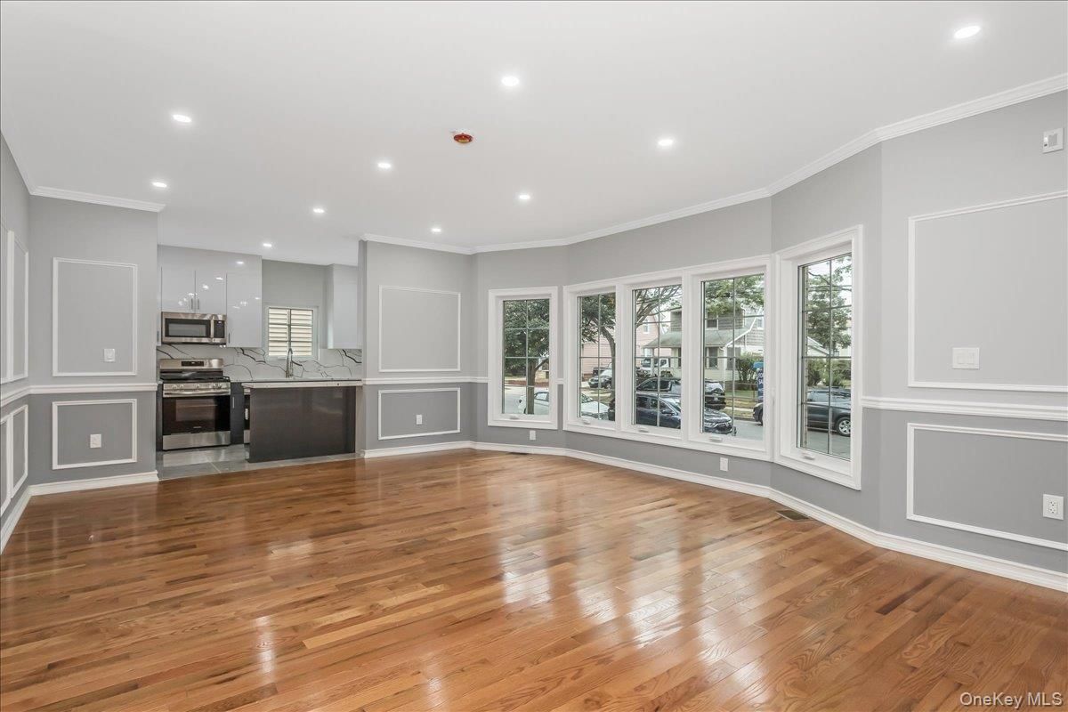 Empty room, Interior, Kitchen, Recessed Lighting, Stainless Steel Appliances, Wood Texture Flooring