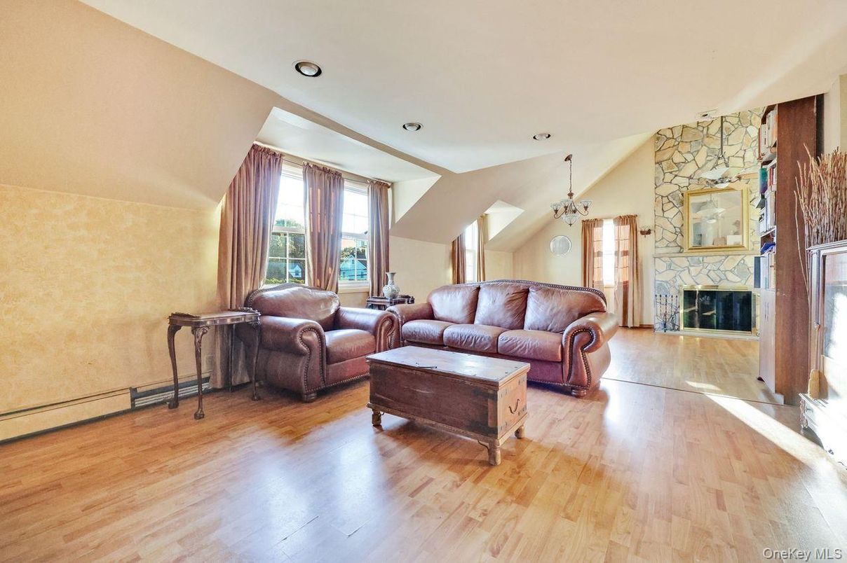 Chandelier, Fireplace, Interior, Living room, Recessed Lighting, Stone Walls, Wood Texture Flooring