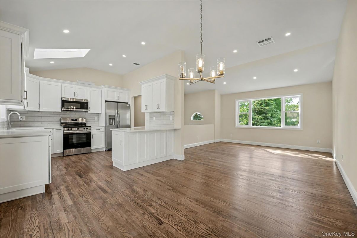 Empty room, Interior, Kitchen, Pendant Lights, Recessed Lighting, Stainless Steel Appliances, Wood Texture Flooring