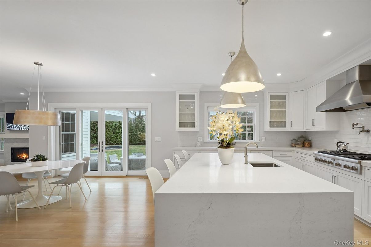 Dining room, Fireplace, Interior, Kitchen, Pendant Lights, Recessed Lighting, Stainless Steel Appliances, Wood Texture Flooring