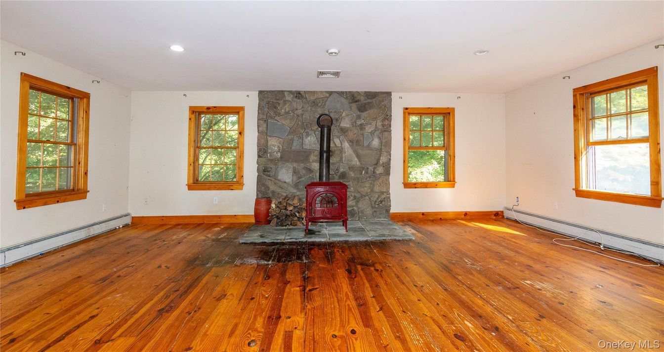 Empty room, Fireplace, Interior, Recessed Lighting, Stone Walls, Wood Texture Flooring