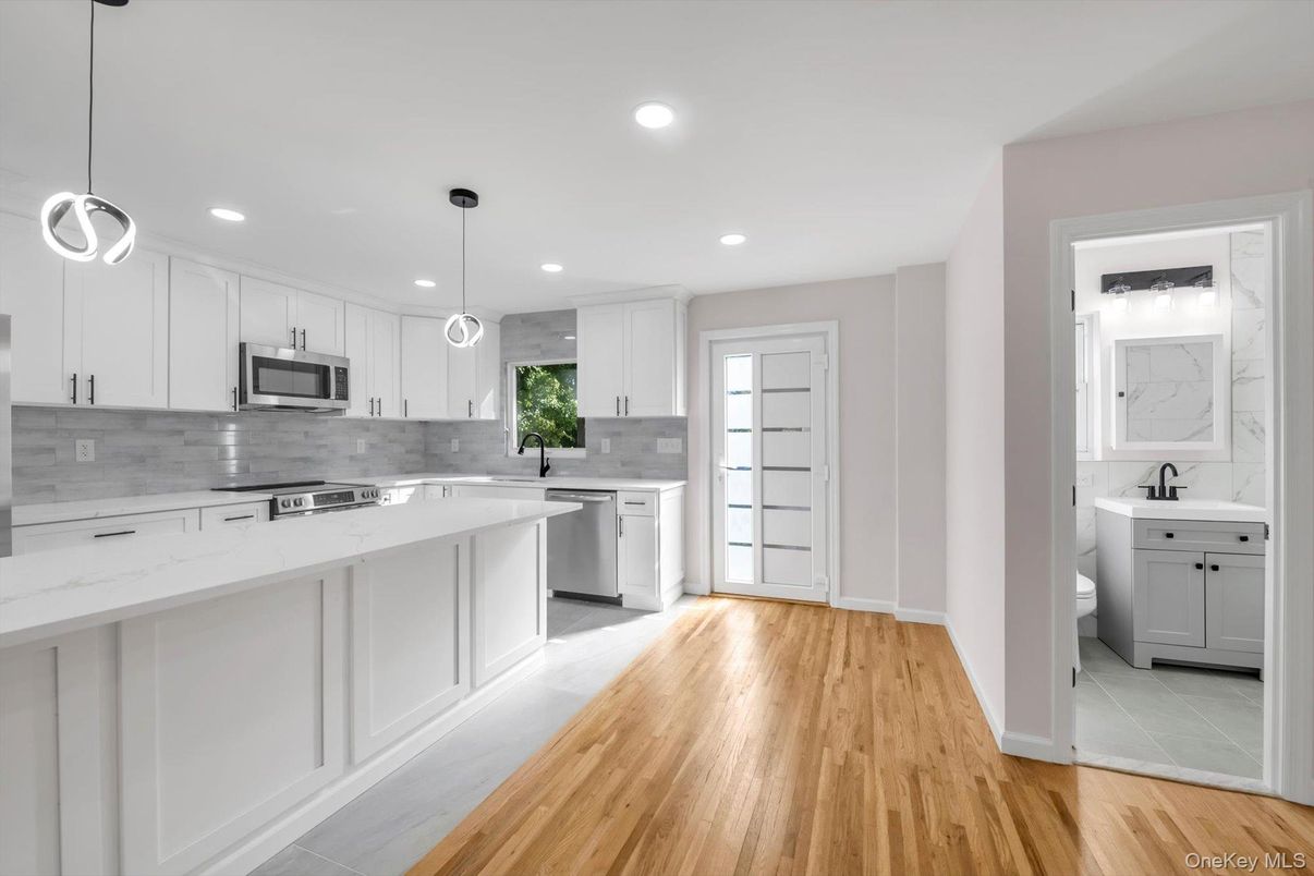 Interior, Kitchen, Marble Walls, Pendant Lights, Recessed Lighting, Stainless Steel Appliances, Wood Texture Flooring
