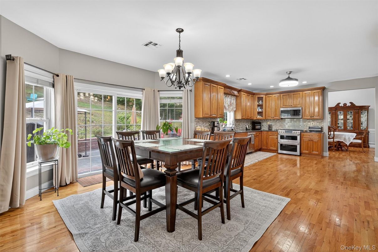 Chandelier, Dining room, Interior, Kitchen, Recessed Lighting, Stainless Steel Appliances, Wood Texture Flooring