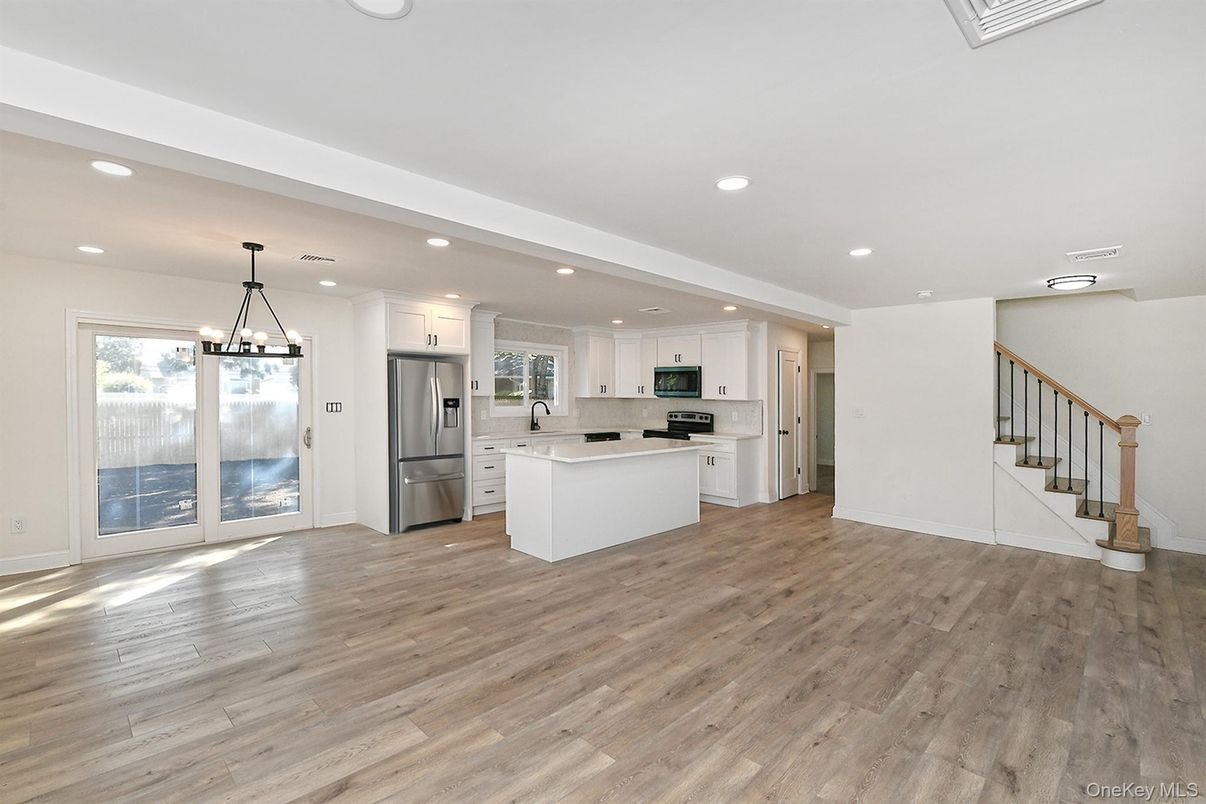 Chandelier, Empty room, Interior, Kitchen, Pendant Lights, Recessed Lighting, Stainless Steel Appliances, Wood Texture Flooring