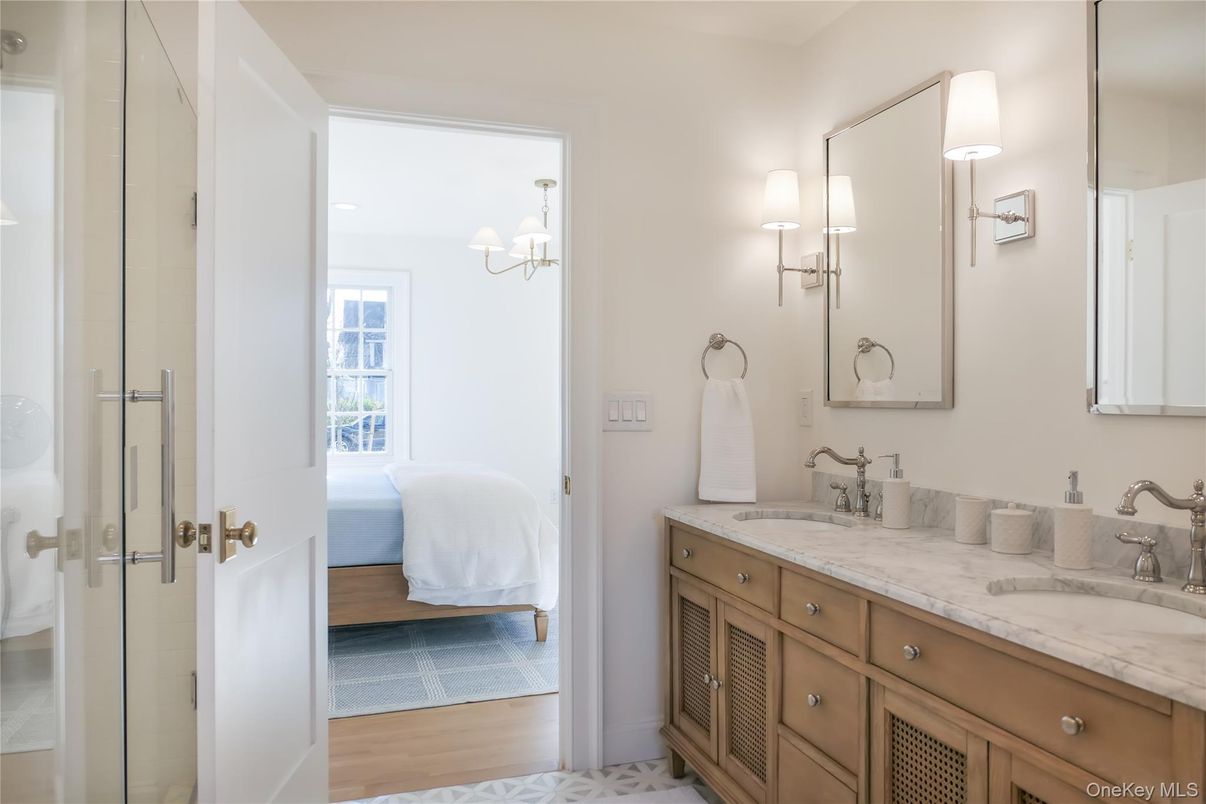 Bathroom, Chandelier, Dual Sink Vanities, Glass Shower, Interior, Wood Texture Flooring