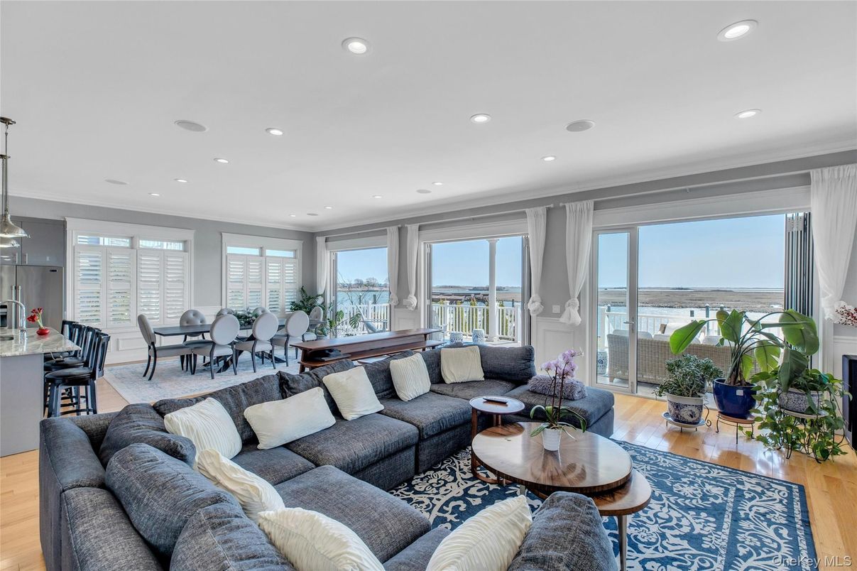 Dining room, Fireplace, Interior, Living room, Recessed Lighting, Water, Wood Texture Flooring