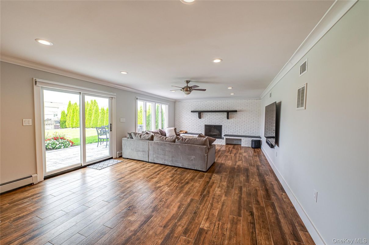 Fireplace, Interior, Living room, Recessed Lighting, Stone Walls, Wood Texture Flooring