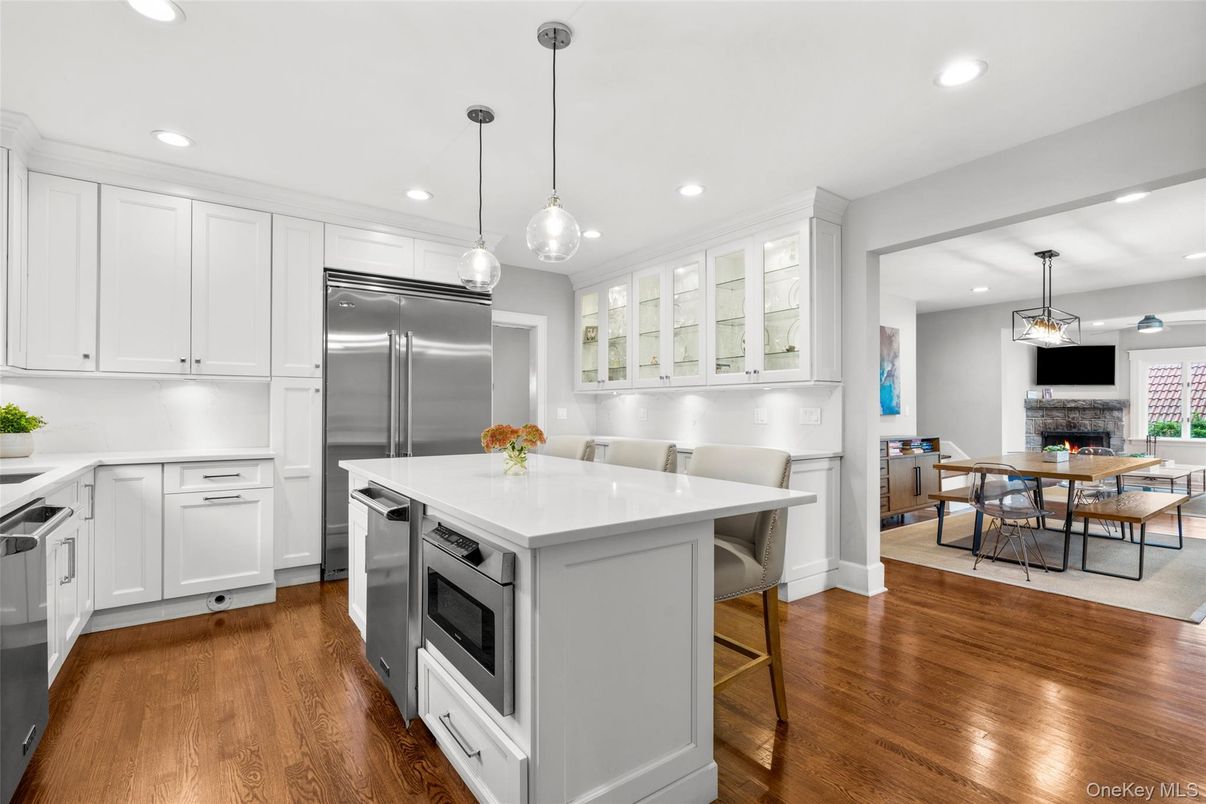 Dining room, Fireplace, Interior, Kitchen, Pendant Lights, Recessed Lighting, Stainless Steel Appliances, Wood Texture Flooring