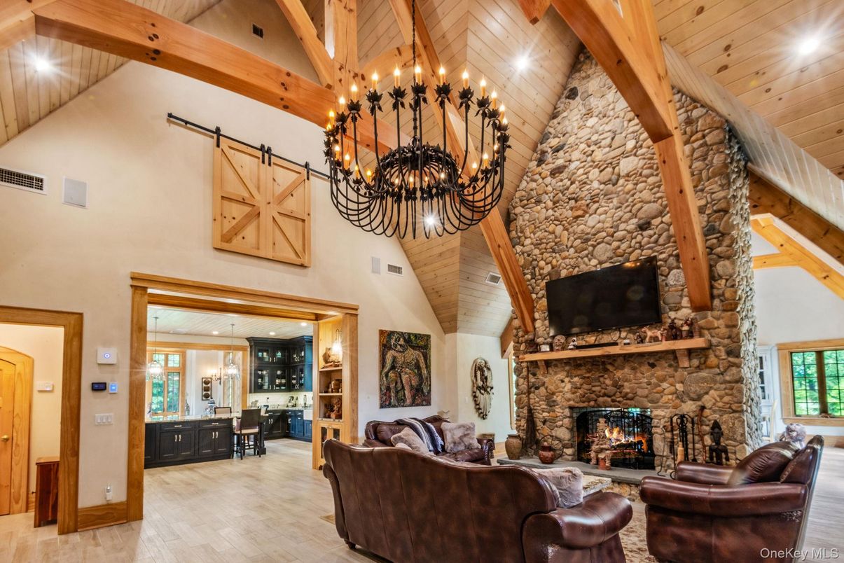 Chandelier, Fireplace, Interior, Living room, Recessed Lighting, Stone Walls, Wooden Beams, Wooden Ceilings, Wood Texture Flooring