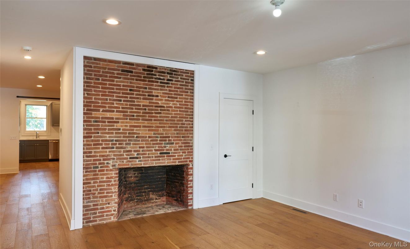 Empty room, Fireplace, Interior, Recessed Lighting, Stone Walls, Wood Texture Flooring