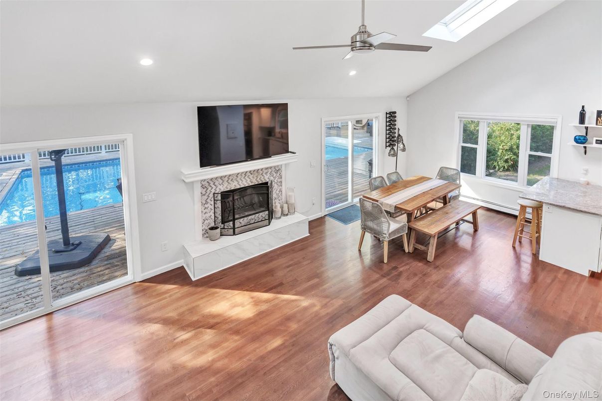 Dining room, Fireplace, Interior, Living room, Recessed Lighting, Wood Texture Flooring