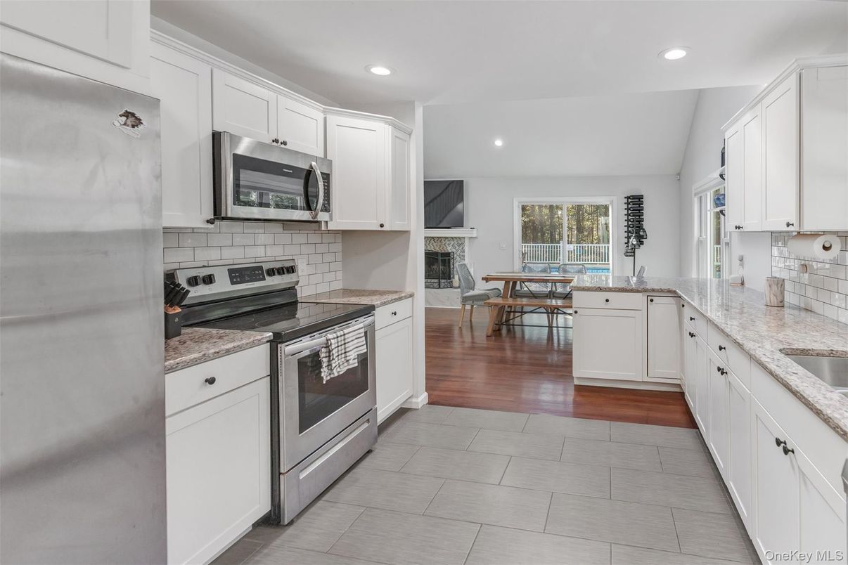 Dining room, Fireplace, Interior, Kitchen, Recessed Lighting, Stainless Steel Appliances, Wood Texture Flooring