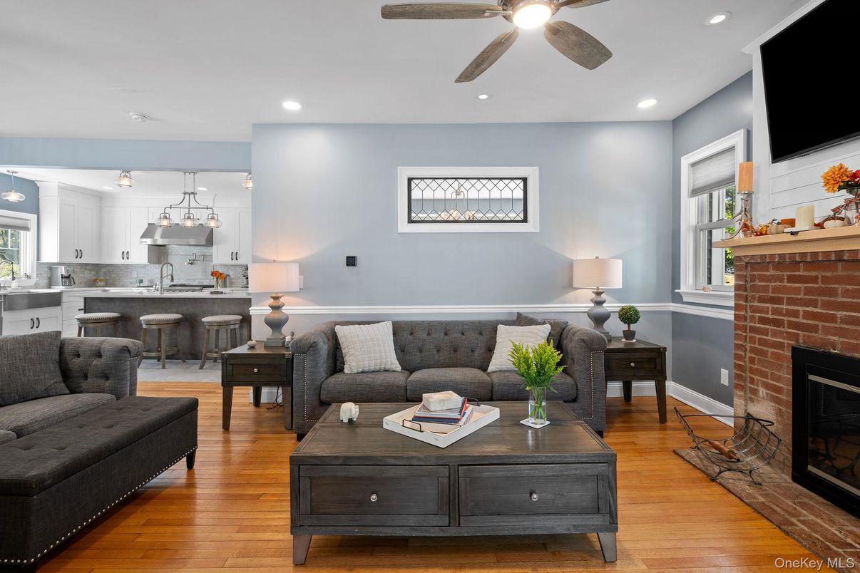 Fireplace, Interior, Kitchen, Living room, Pendant Lights, Recessed Lighting, Stainless Steel Appliances, Stone Walls, Wood Texture Flooring