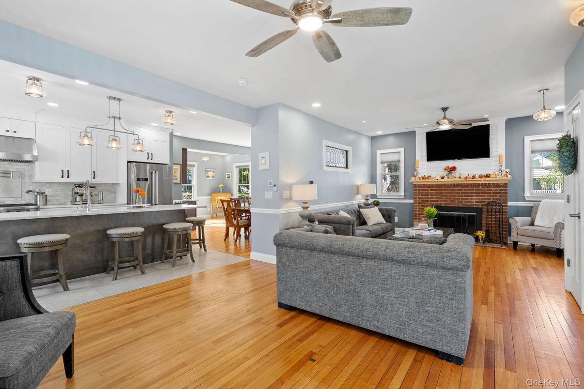 Fireplace, Interior, Kitchen, Living room, Pendant Lights, Recessed Lighting, Stainless Steel Appliances, Wood Texture Flooring