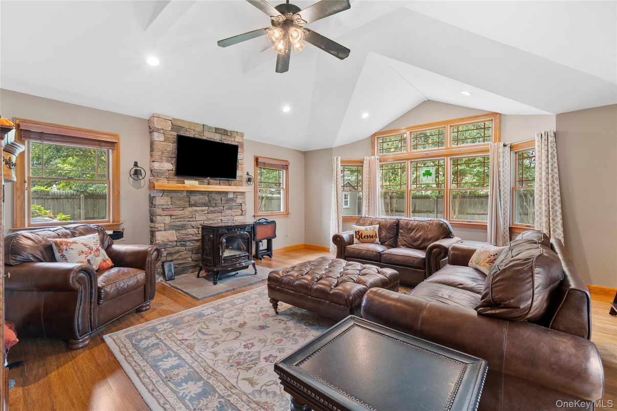 Fireplace, Interior, Living room, Recessed Lighting, Stone Walls, Wood Texture Flooring