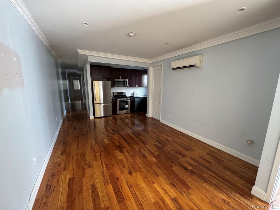 Empty room, Interior, Kitchen, Recessed Lighting, Stainless Steel Appliances, Wood Texture Flooring