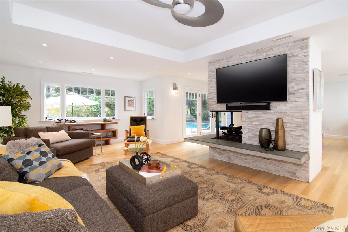 Fireplace, Interior, Living room, Recessed Lighting, Stone Walls, Wood Texture Flooring