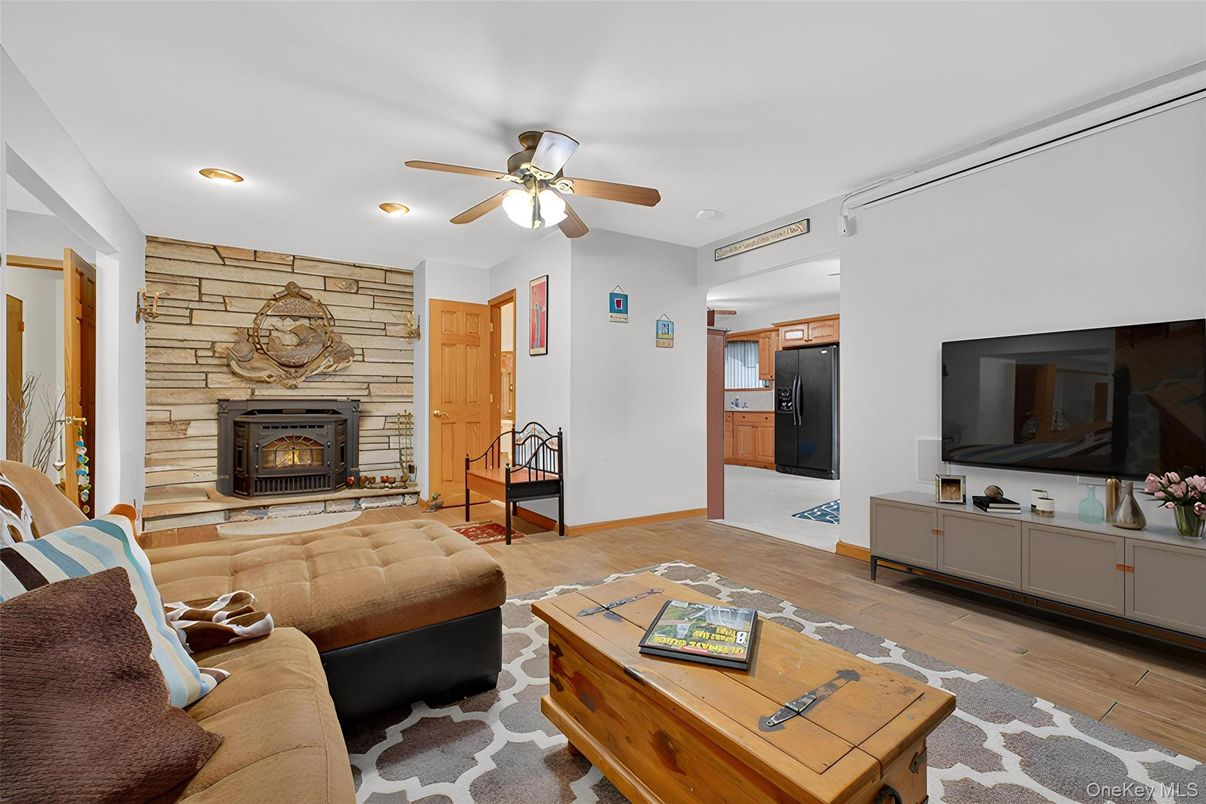 Fireplace, Interior, Living room, Recessed Lighting, Stone Walls, Wood Texture Flooring